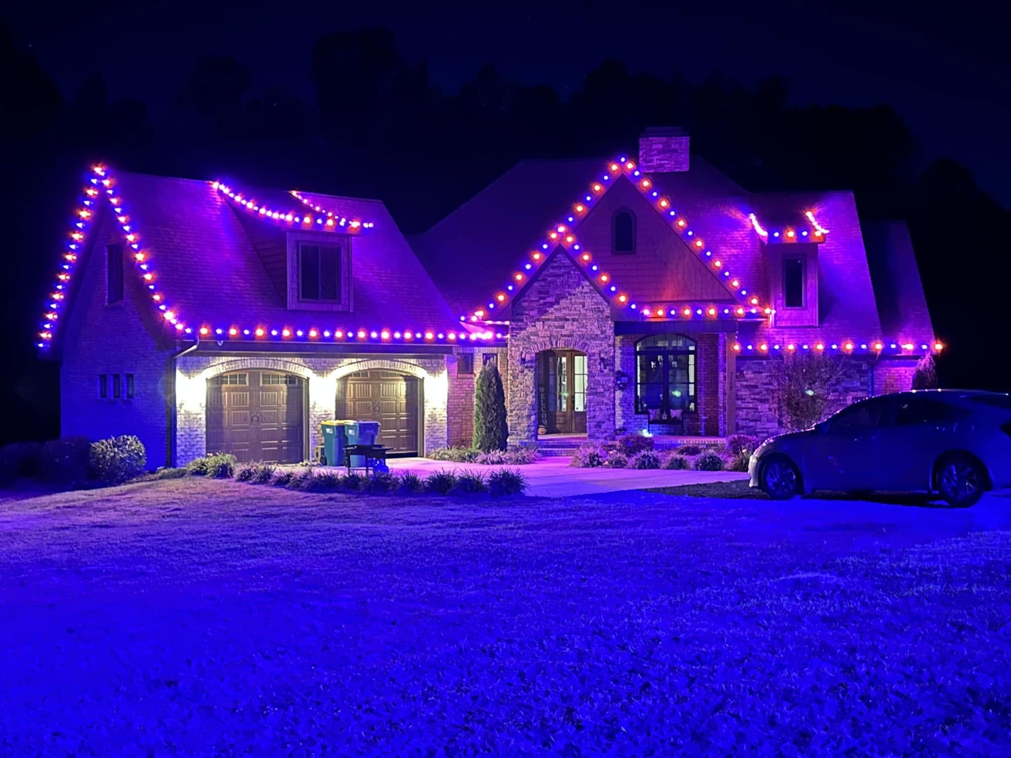 A different AstroLume project with purple and orange roofline lighting on a home